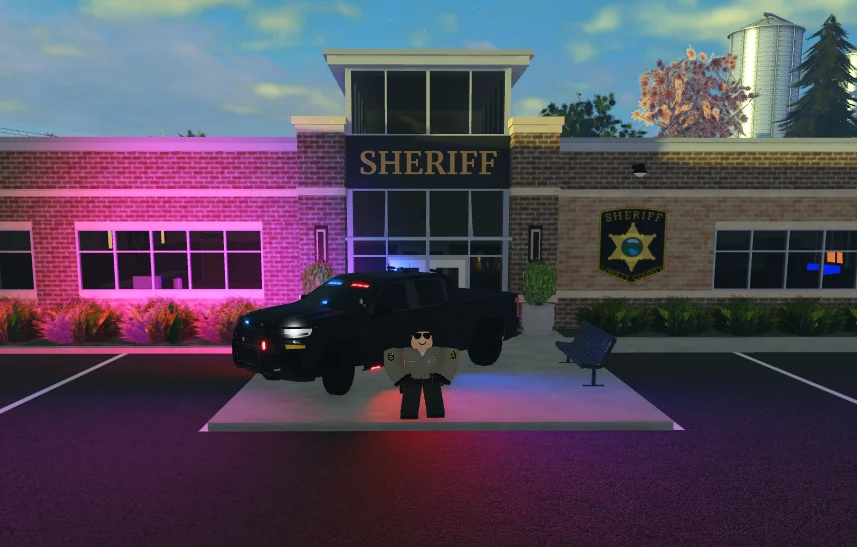A deputy and sheriff vehicle outside the sheriff station